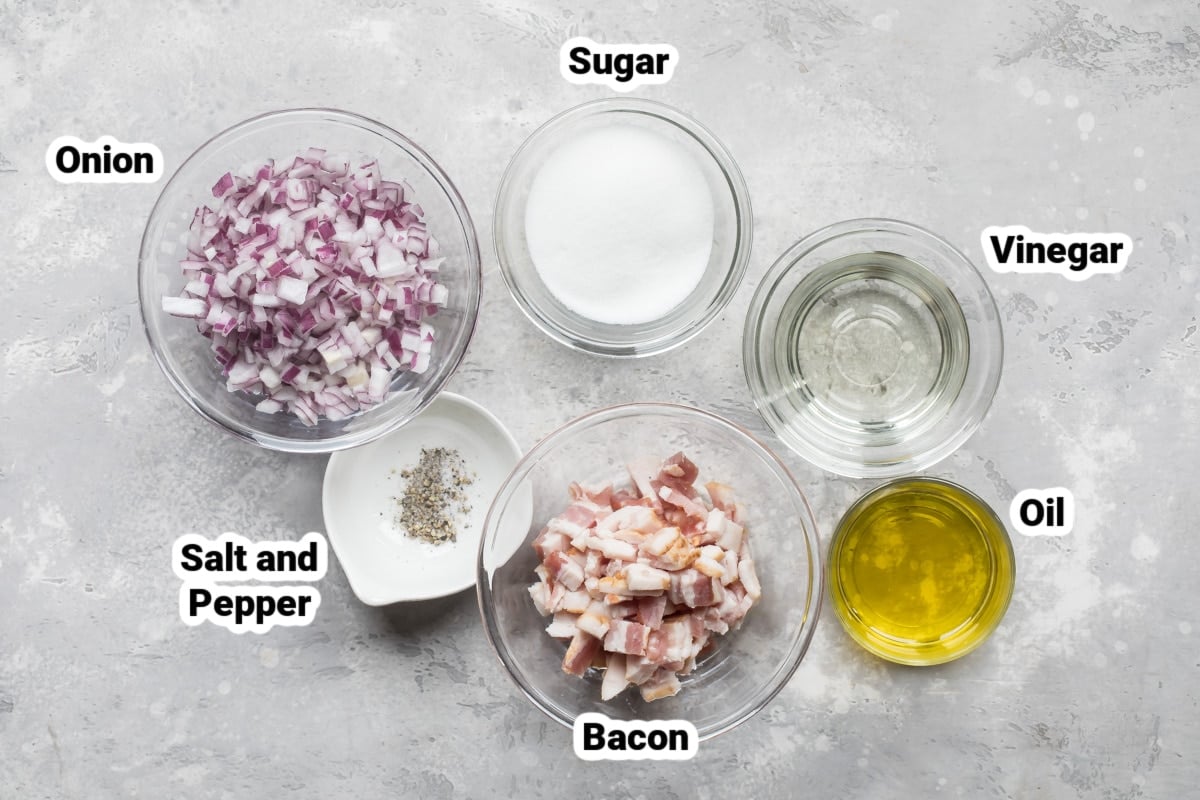 Labeled ingredients for hot bacon dressing in various bowls.