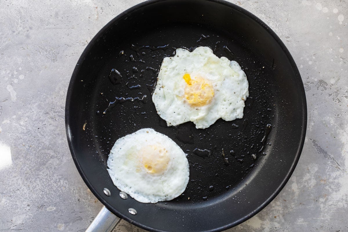 Eggs over easy in a skillet.