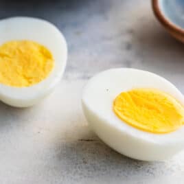 A hard boiled egg sliced in half lengthwise.