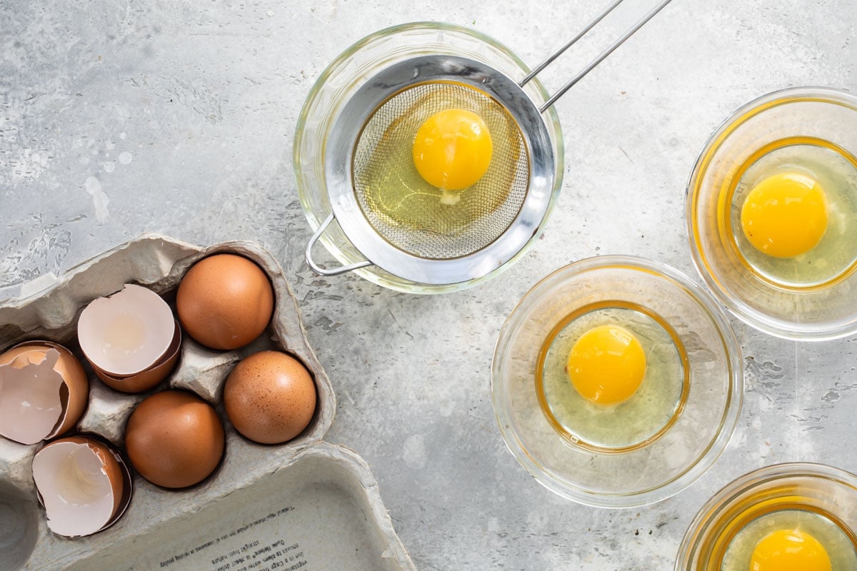 Eggs draining in a sieve before poaching.