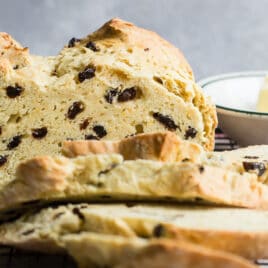 Irish soda bread sliced on a baking rack.
