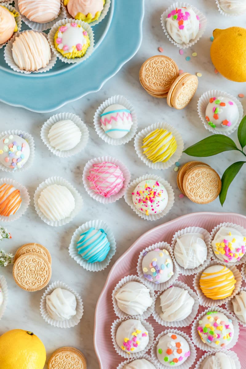 Lemon cookie balls decorated and arranged on a table.