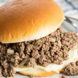 A loose meat sandwich on a plate.