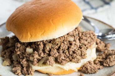 A loose meat sandwich on a plate.