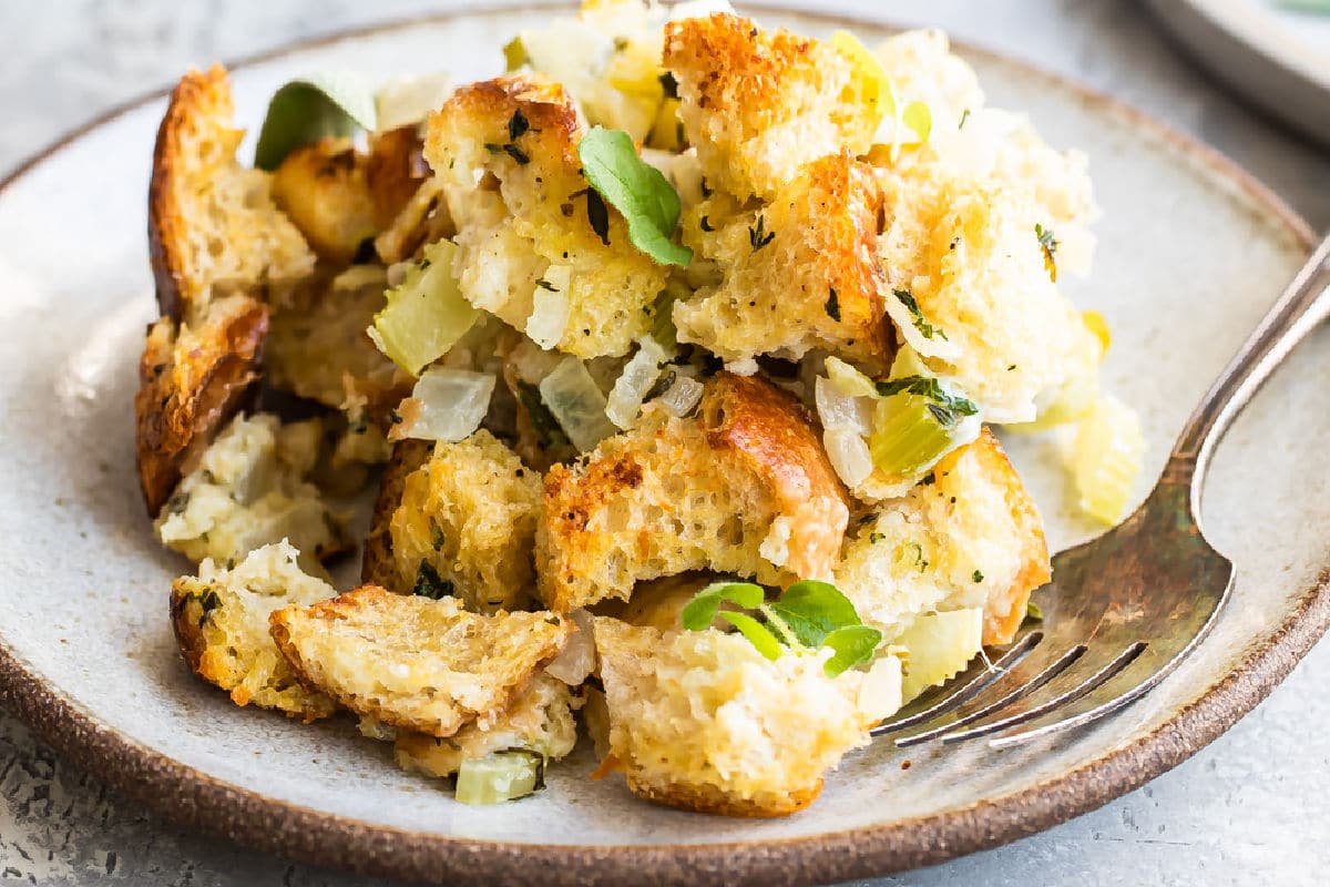 Bread stuffing on a plate with a fork.