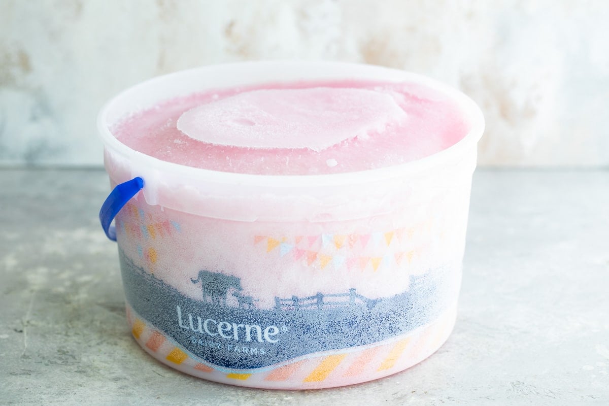 Pink lemonade vodka slush in a ice cream pail.