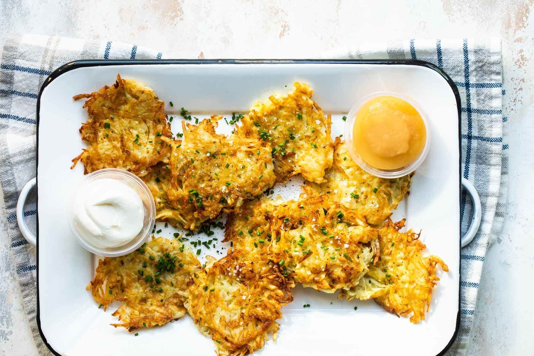 Potato latkes on a rectangular platter.