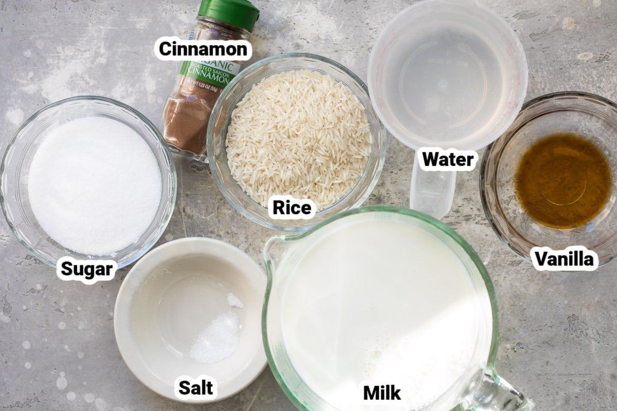 Labeled ingredients for rice pudding in various bowls.