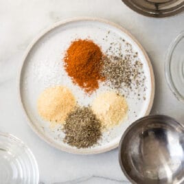 Rotisserie chicken seasoning ingredients on a white plate.
