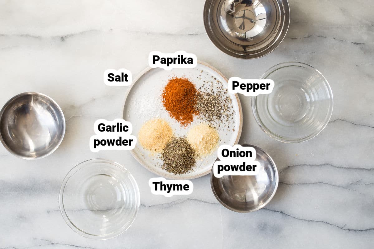 Rotisserie chicken seasoning ingredients on a white plate.