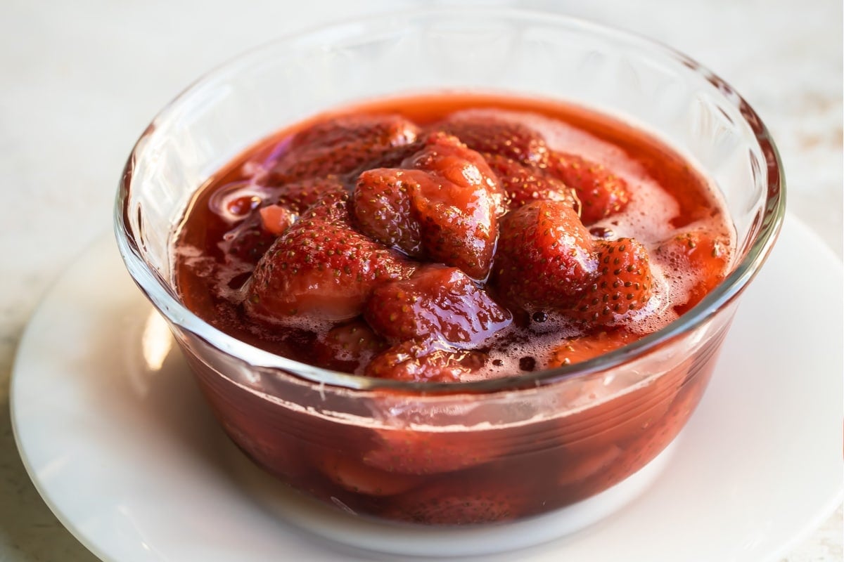 A bowl of strawberry topping.