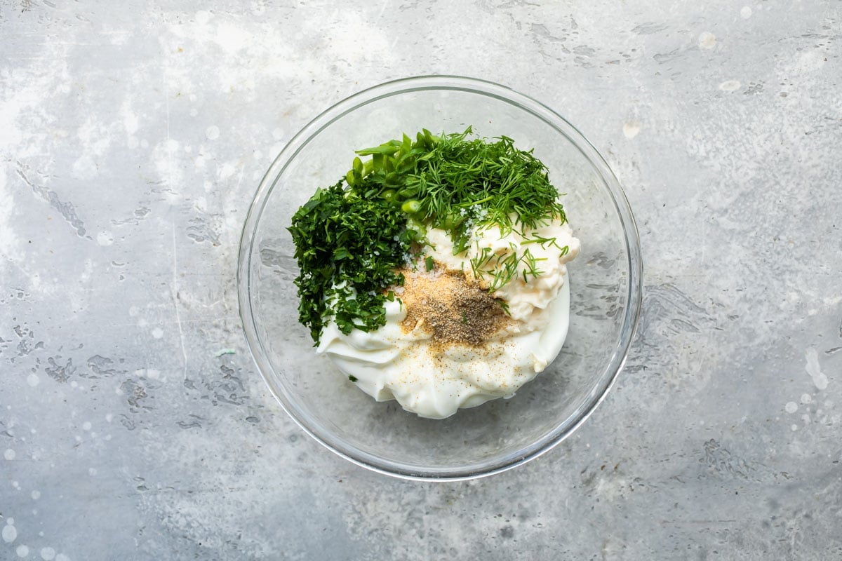 Veggie dip ingredients in a bowl before being mixed.