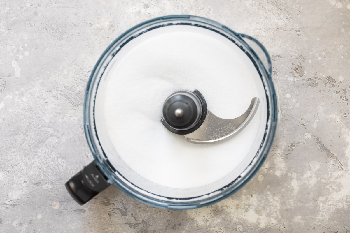 Sugar and flour being blitzed in a food processor.