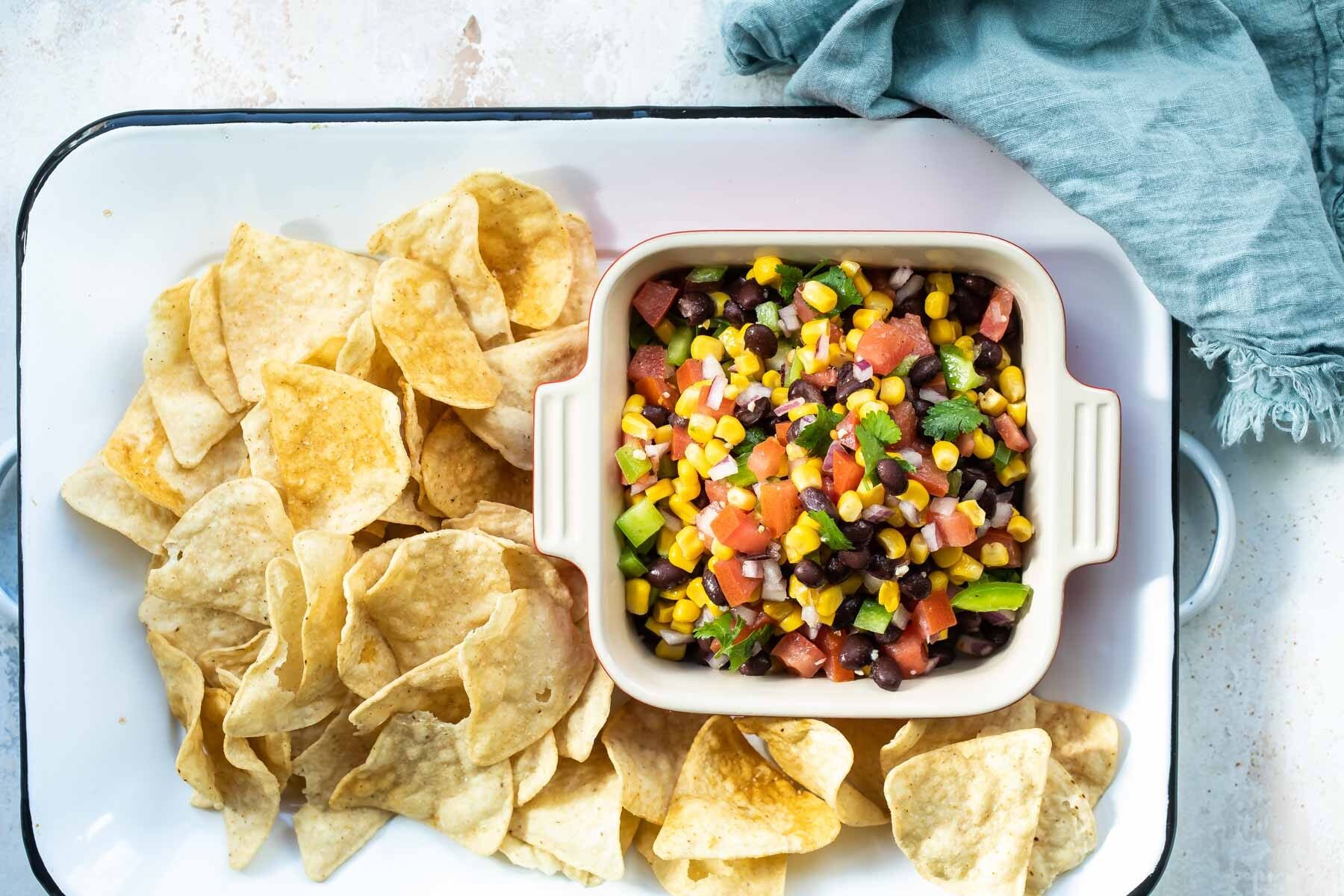 Black bean salsa in a red square dish.