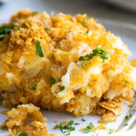 A pile of cheesy potato casserole on a plate.