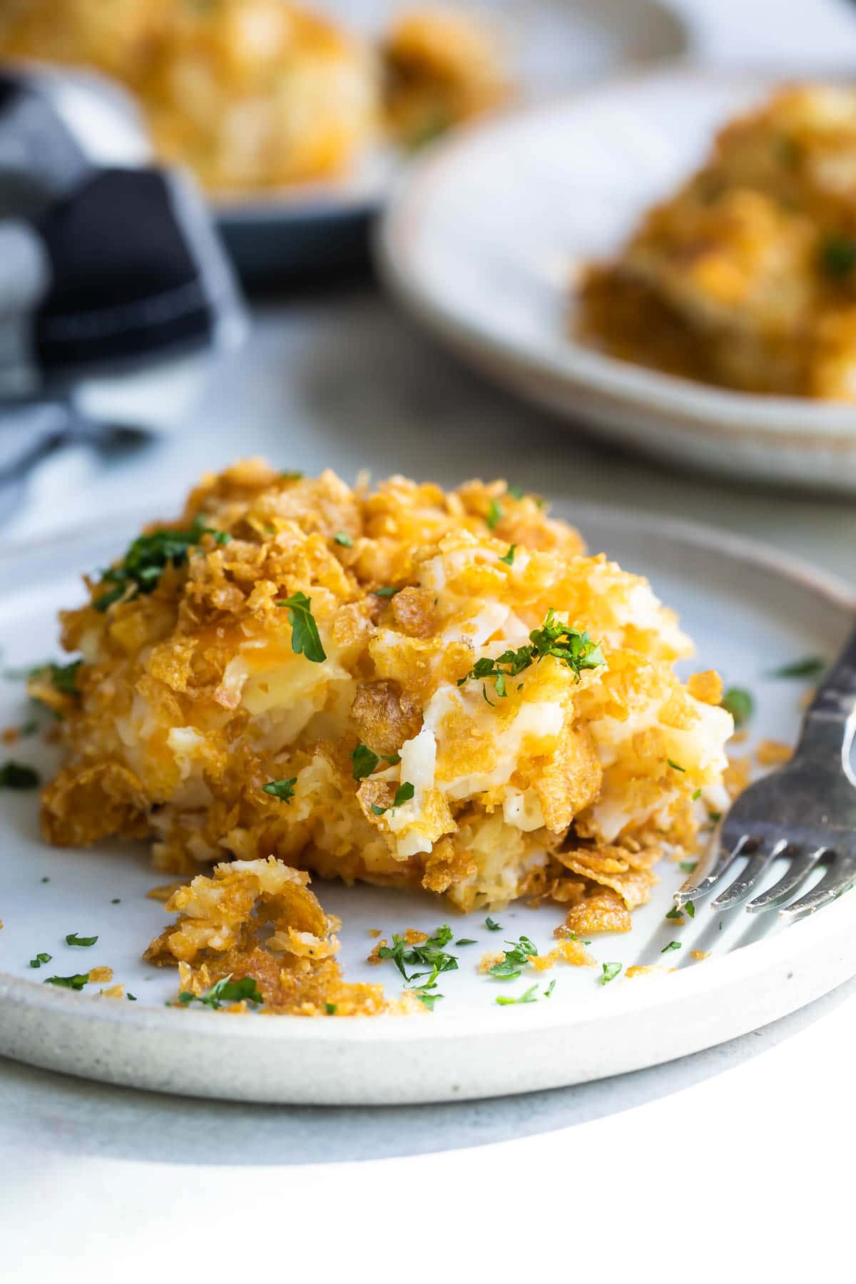 A pile of cheesy potato casserole on a plate.