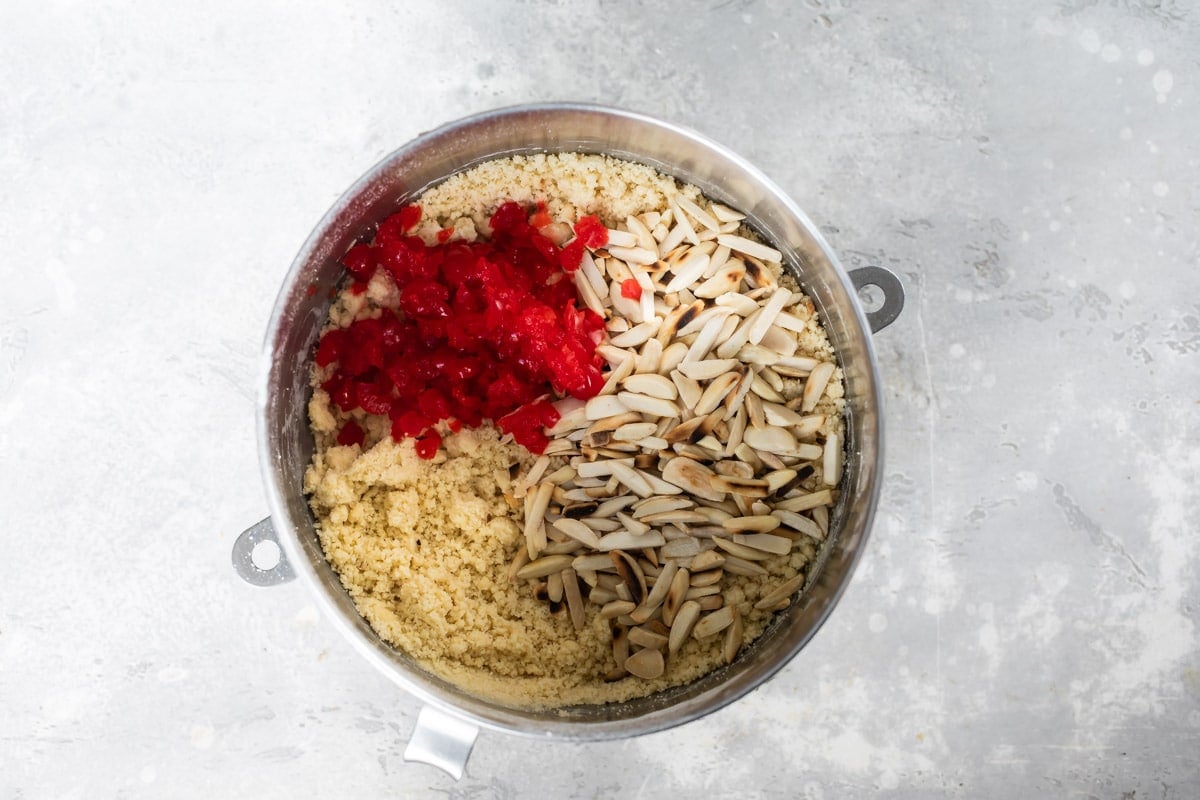 Ingredients for cherry almond biscotti in a mixing bowl.