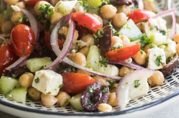 Chickpea salad on a black and white serving platter.