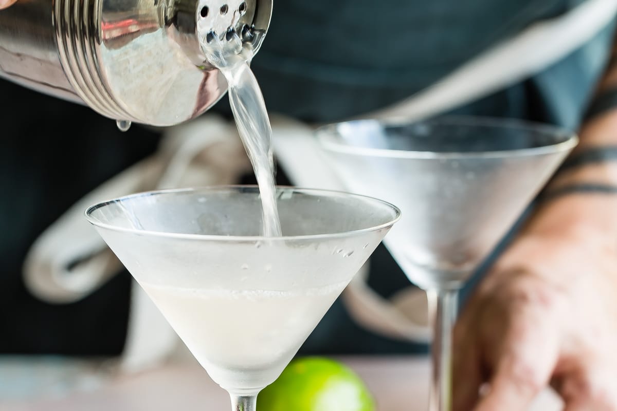 Pouring a Hemingway Daiquiri into a cocktail glass.