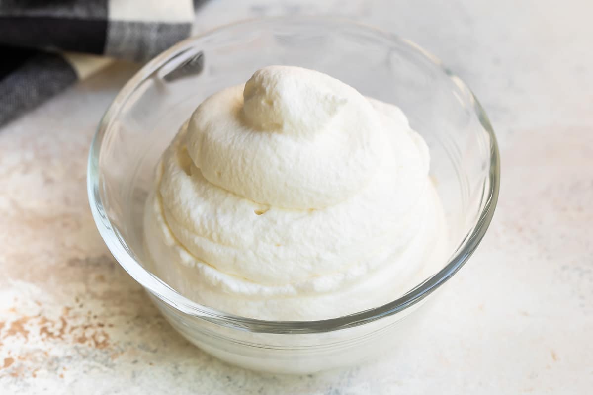 A bowl filled with piped whipped cream.