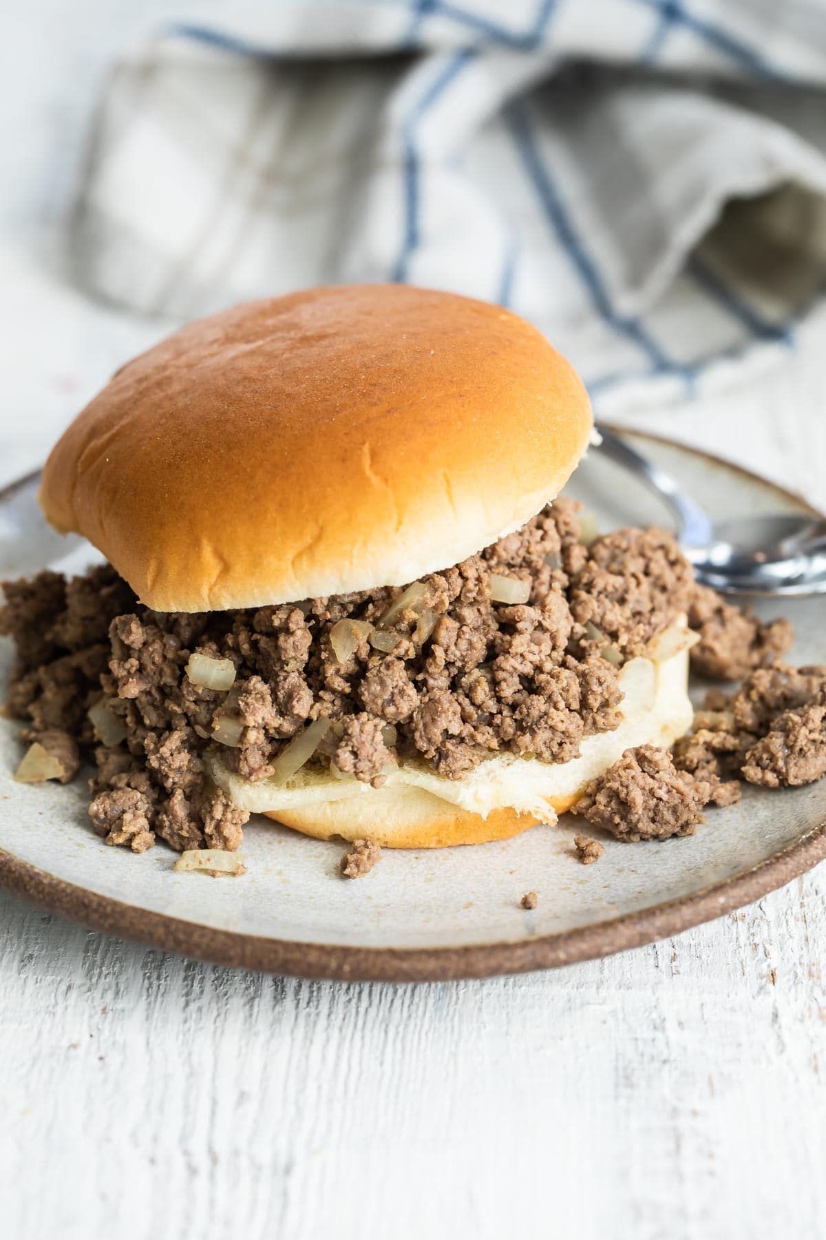 A loose meat sandwich on a plate.
