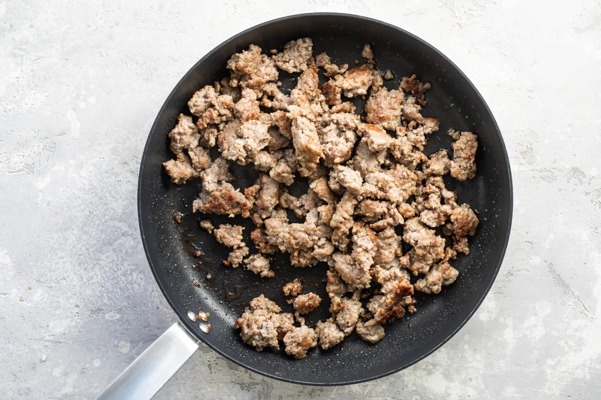 Sausage cooking in a skillet.