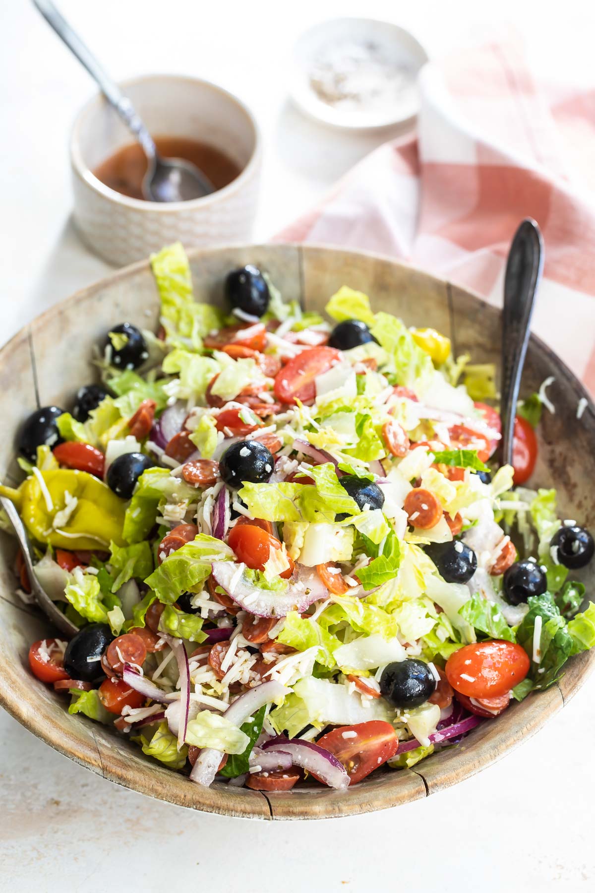 Antipasto salad mixed in a wooden bowl.
