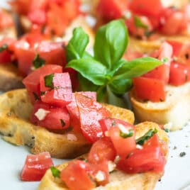 Bruschetta on a white platter.