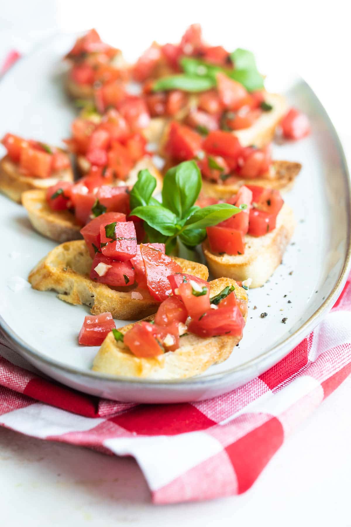Bruschetta on a white platter.