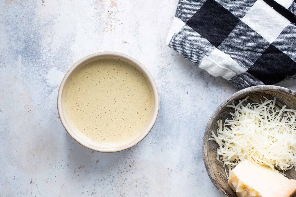 Caesar salad dressing in a ramekin.