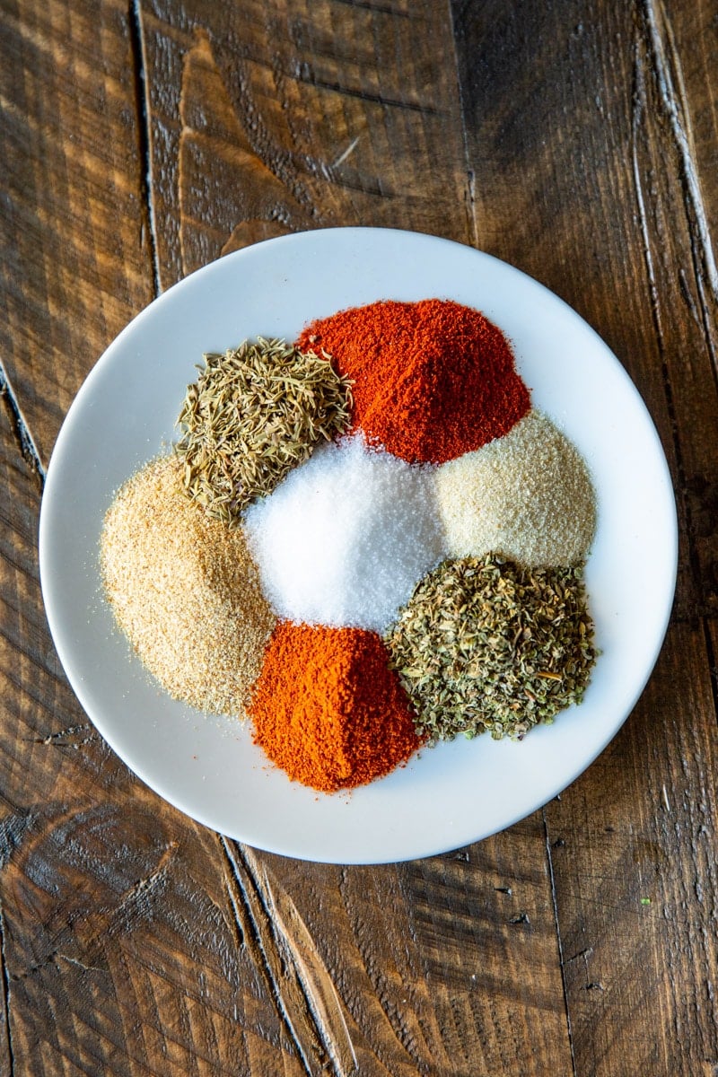 Cajun seasoning spices on a white plate.