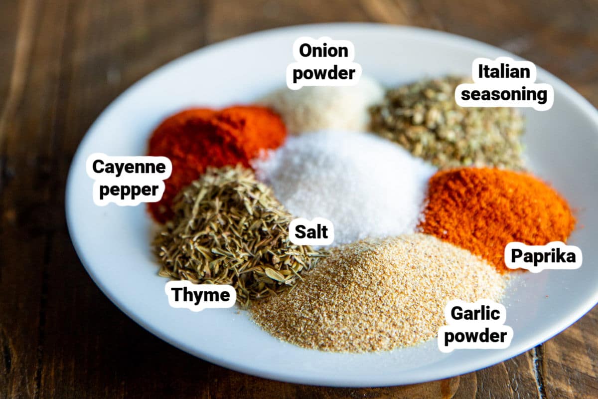 Cajun seasoning spices on a white plate.