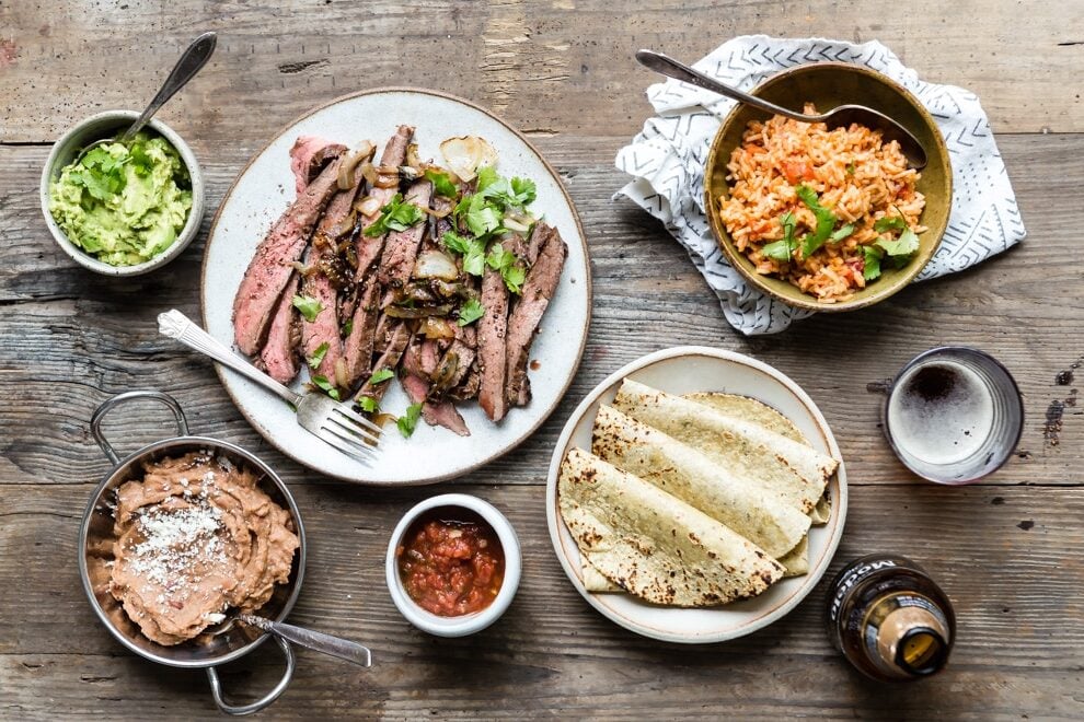 It's summer grilling season; if you follow your nose in Southern California, chances are you'll find delicious Carne Asada on the coals at every backyard party. Once it's marinated, this irresistible recipe cooks up faster than it takes to finish your first margarita. Make more than you think you need, because everyone loves carne asada with all the fixings. 