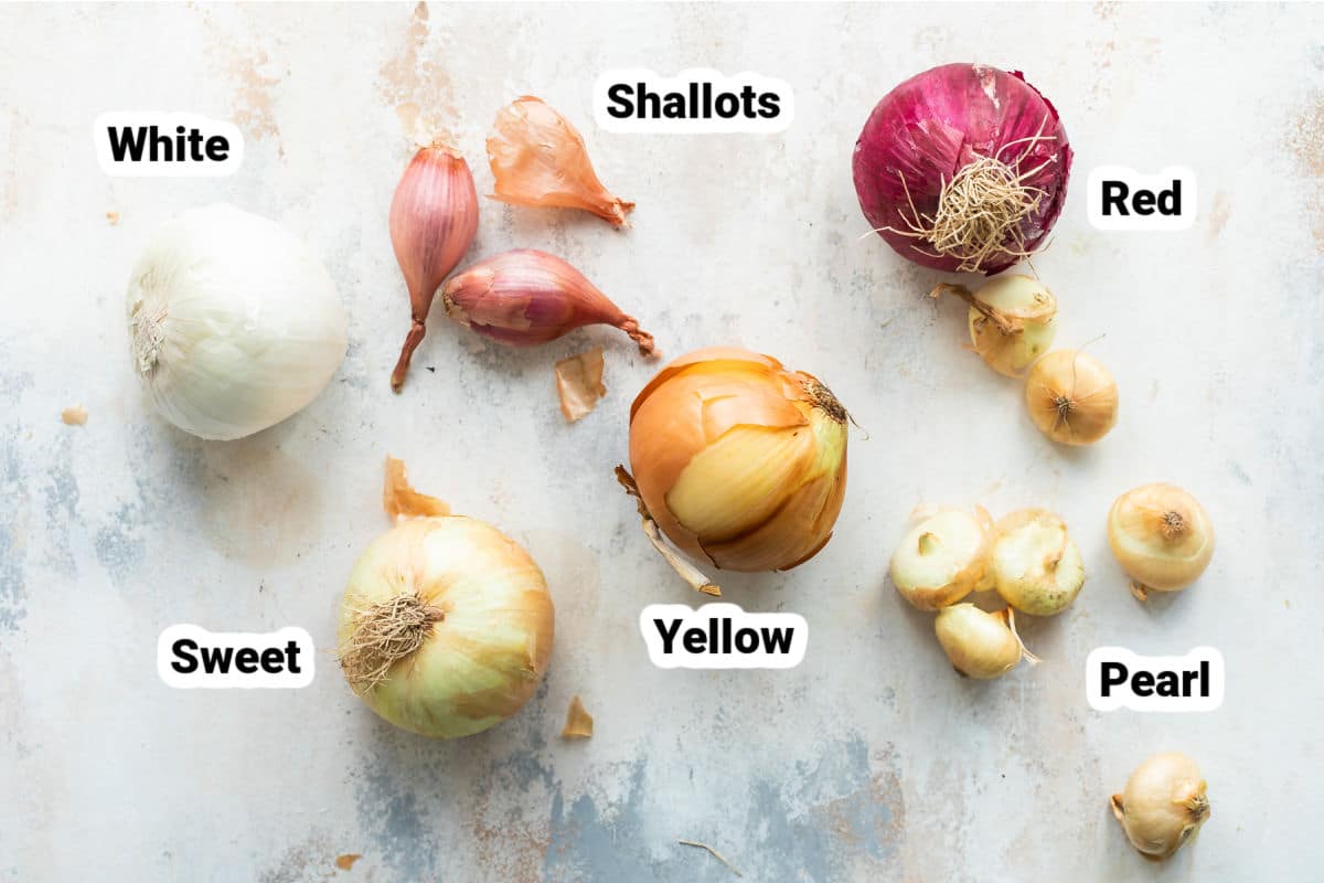 Different types of onions labeled on a board.
