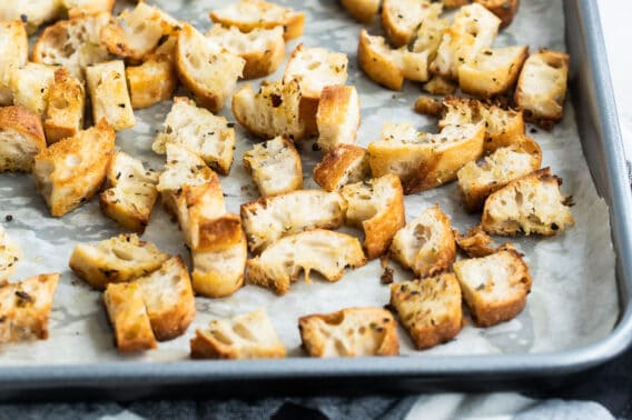 Croutons on a parchment lined baking sheet.