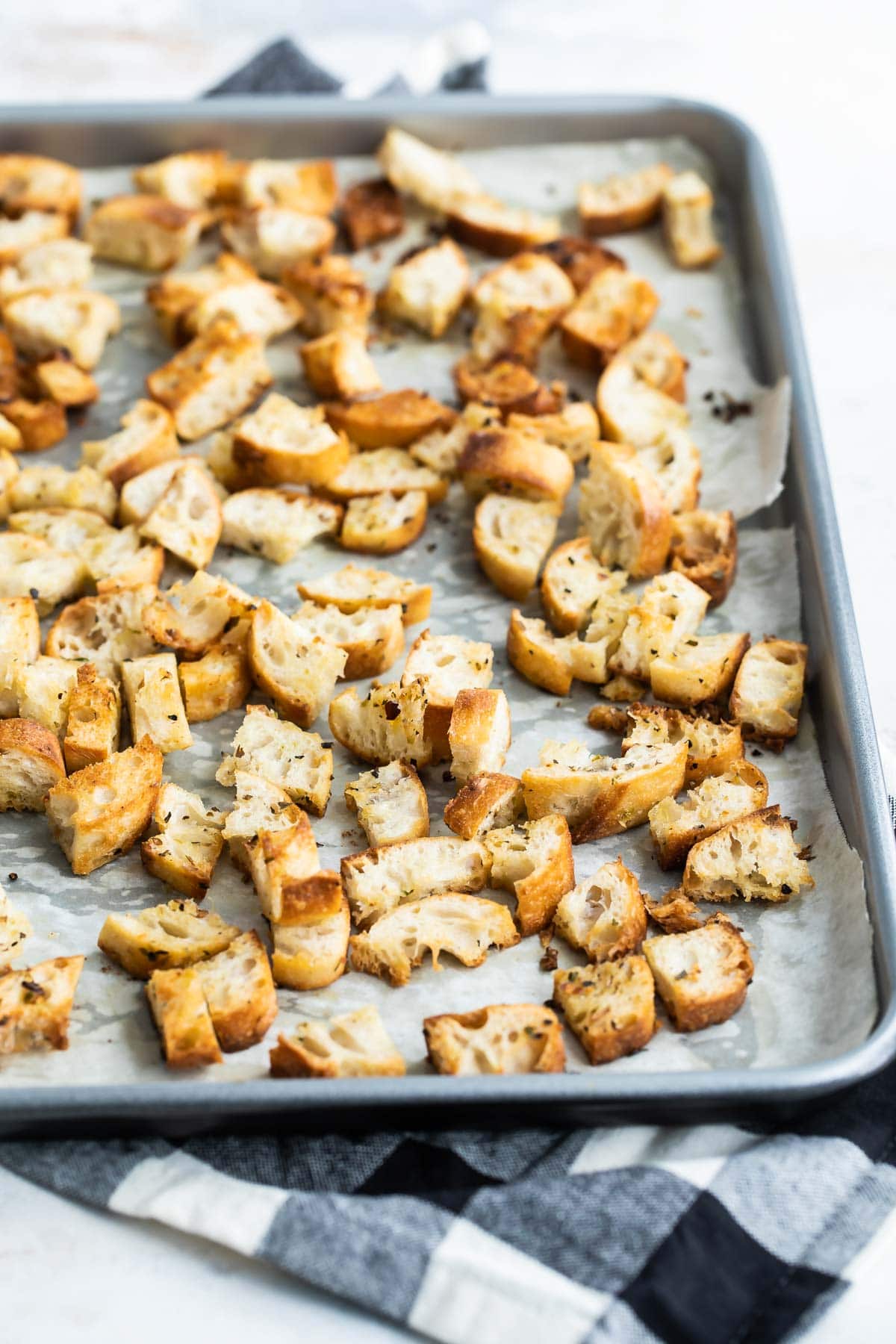 Croutons on a parchment lined baking sheet.