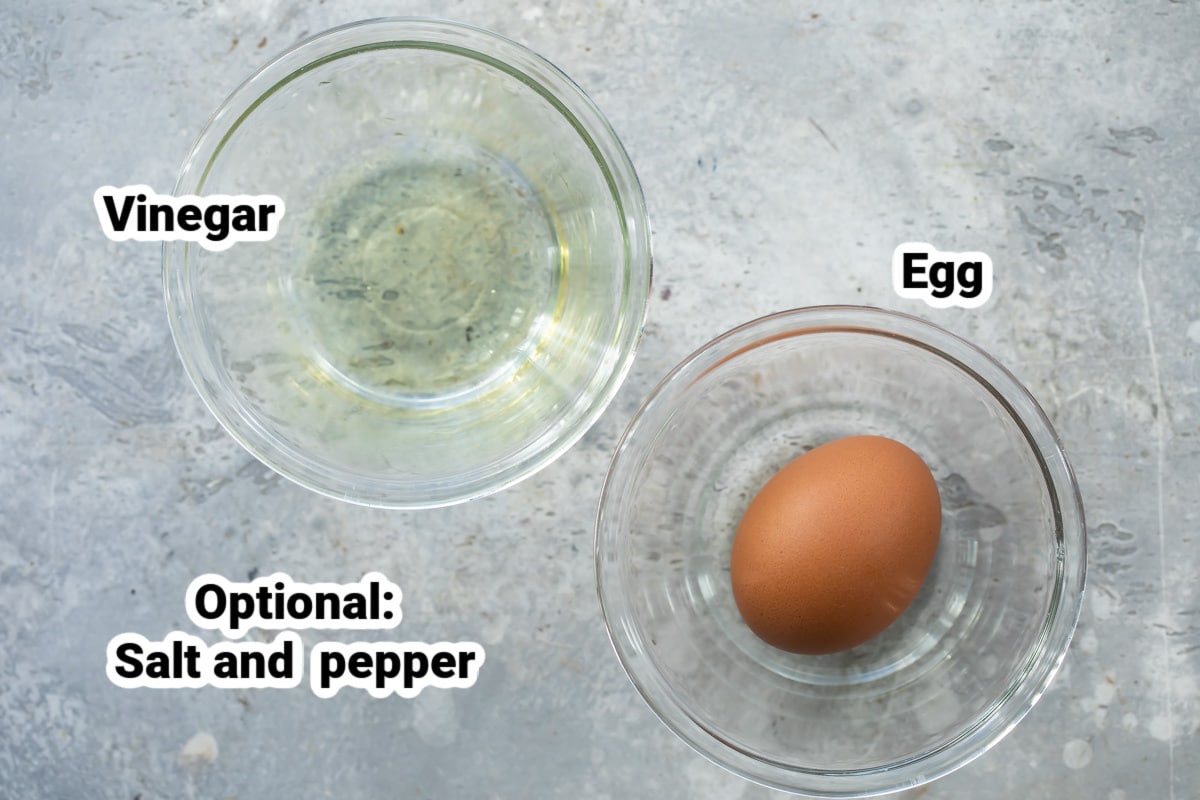 Two bowls with an egg in one and vinegar in another.