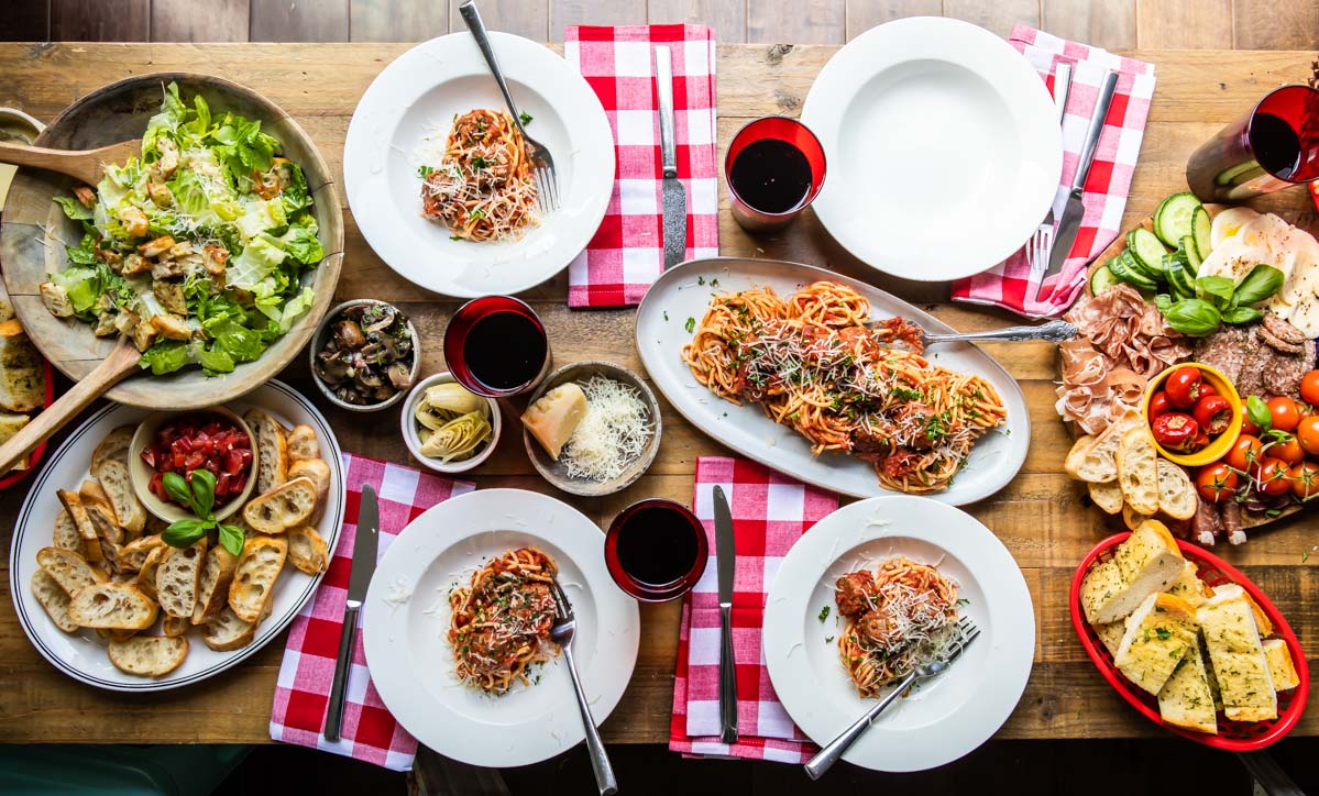 A spread of Italian food on a wooden table.