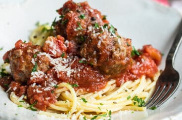 Spaghetti and meatballs on a white platter.