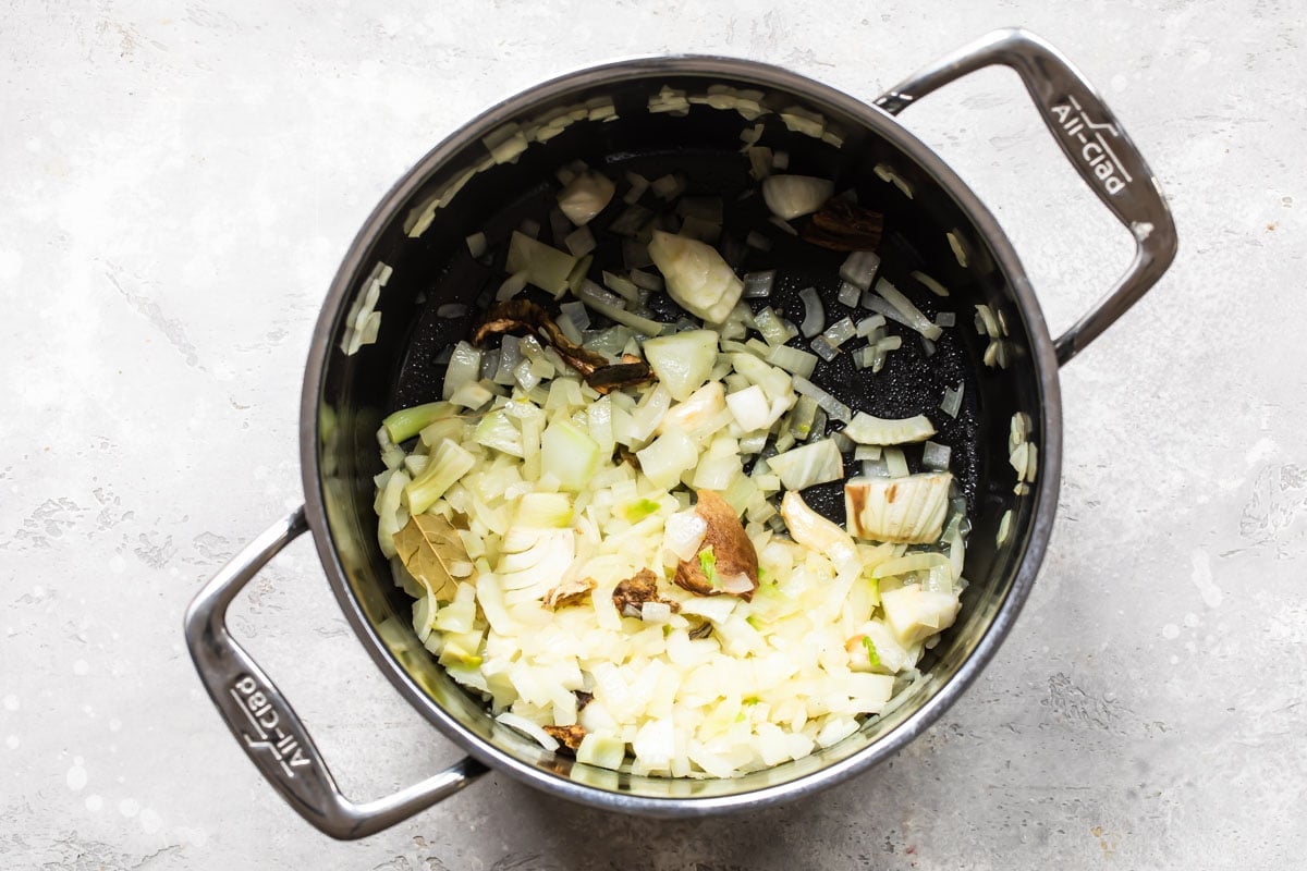 Onion being cooked in a stock pot.