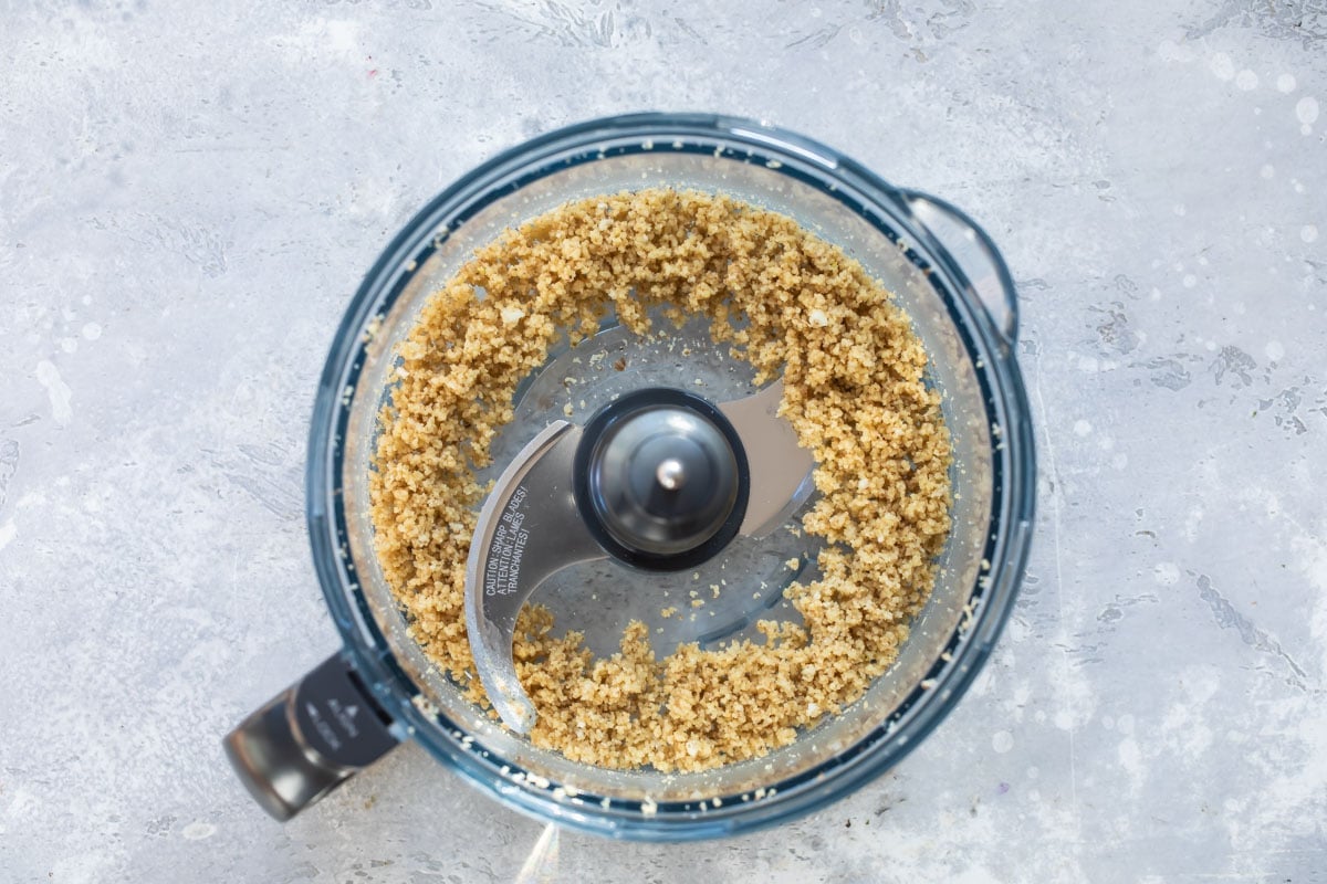 Chopped walnuts in a food processor.
