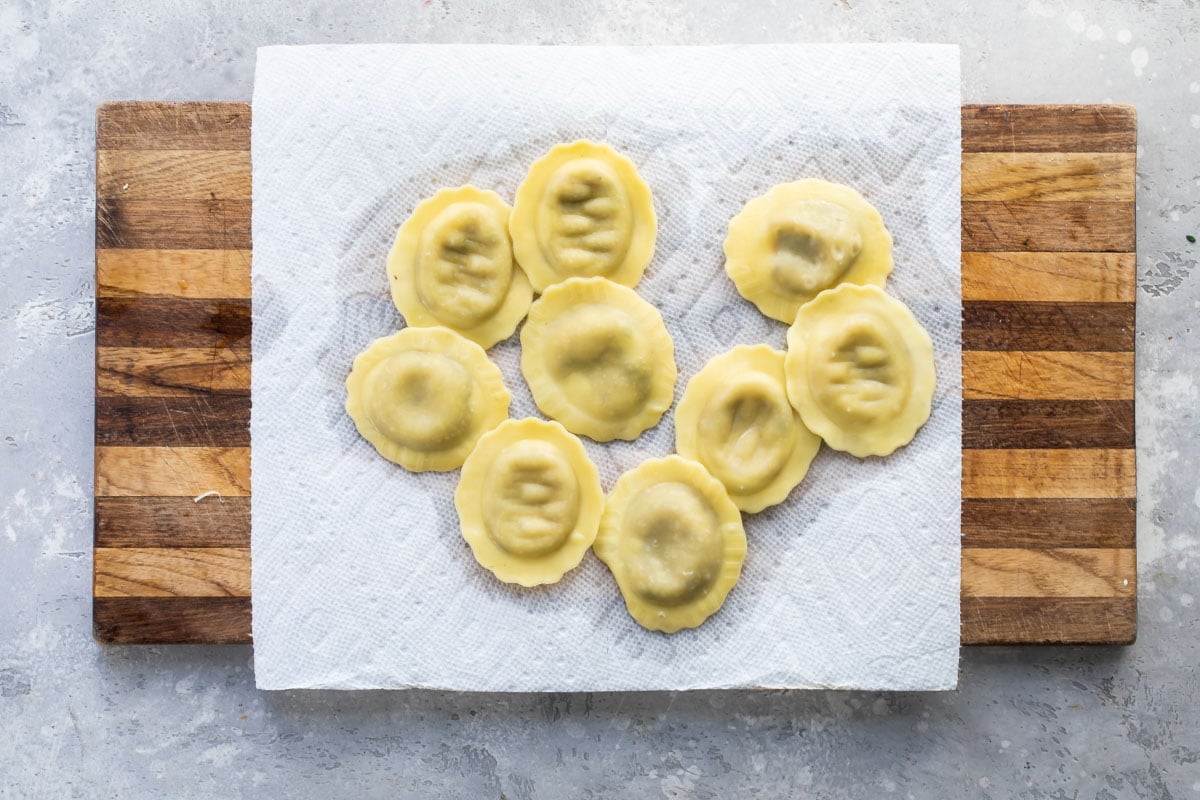 Cooked mushroom ravioli on a paper towel.