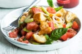 Two plates with Panzanella salad.