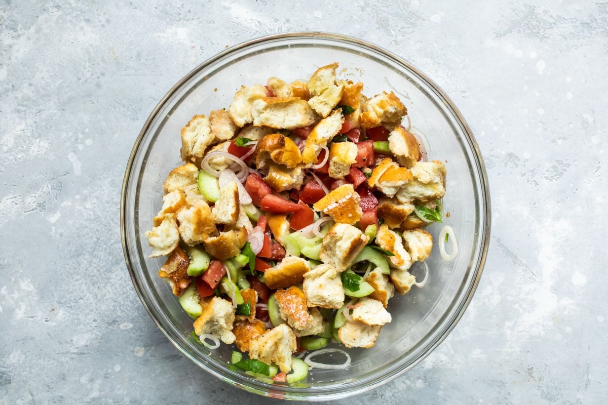 Panzanella salad in a clear bowl.