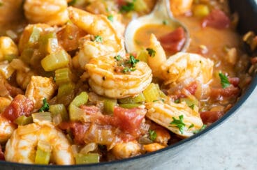 Shrimp creole in a black bowl.