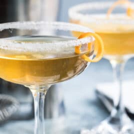 Sidecar cocktails in two clear stemmed glasses.