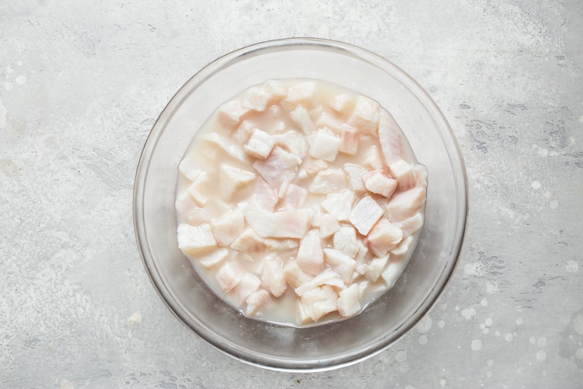 Cubed tilapia in a clear bowl.