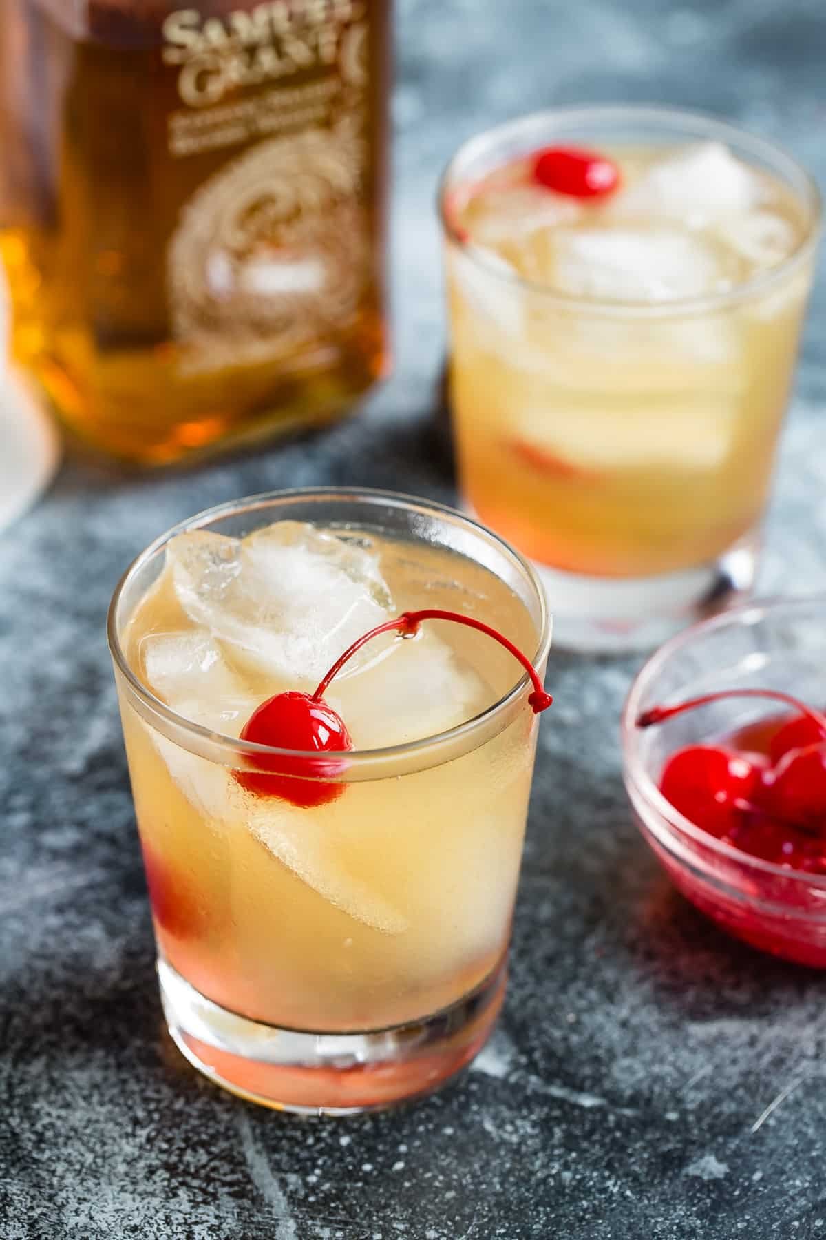 2 whiskey sours in rocks glasses.