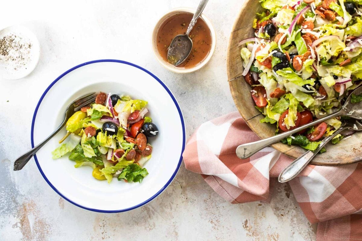 Antipasto salad in a white bowl.