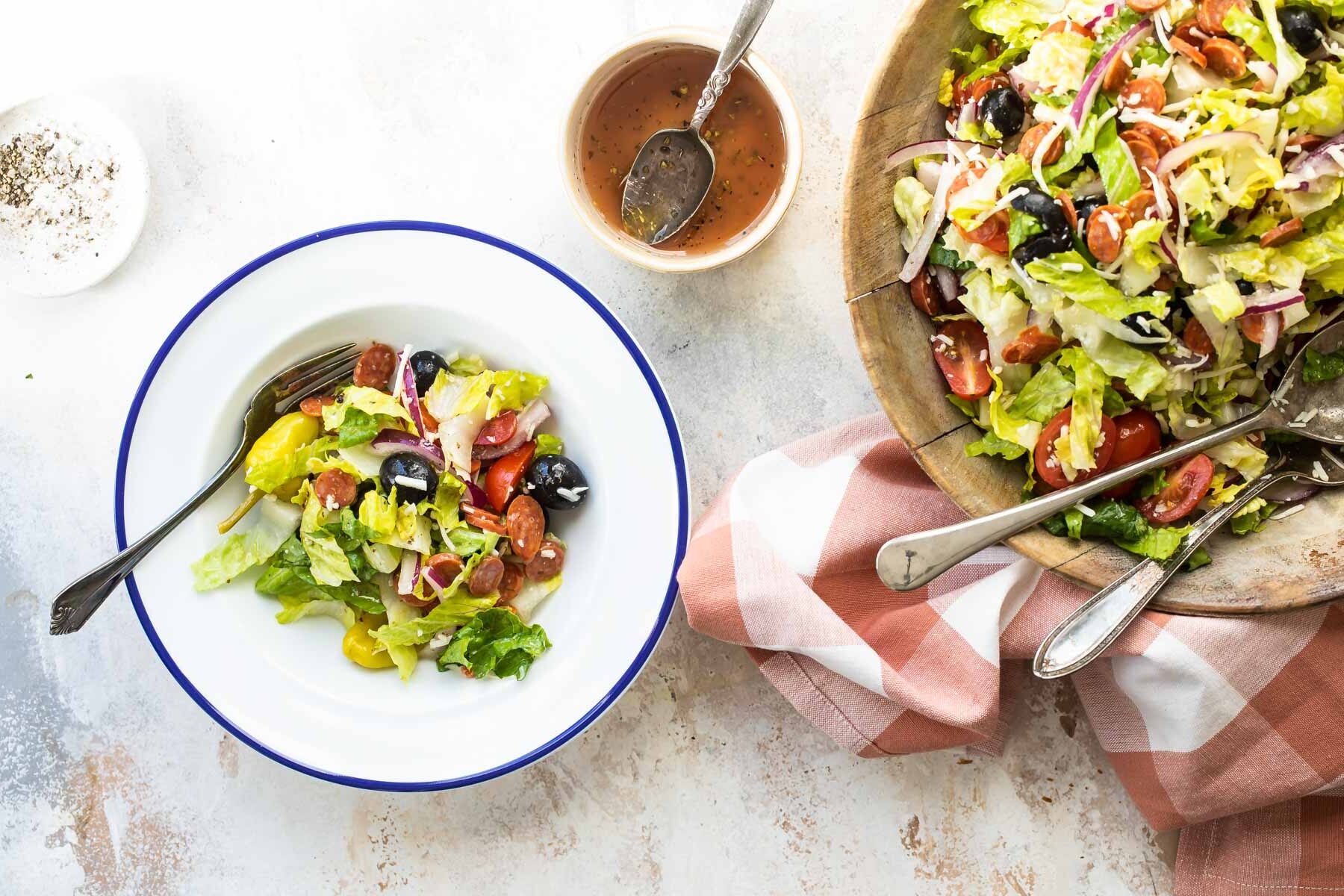 Antipasto salad in a white bowl.